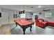 Spacious game room with pool table, foosball table and comfortable seating area at 8222 Valrie Ln, Riverview, FL 33569