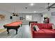 Fully equipped game room with pool table, foosball table, and comfortable seating area at 8222 Valrie Ln, Riverview, FL 33569