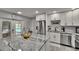 Updated kitchen with granite countertops, stainless appliances, and backyard pool access at 8222 Valrie Ln, Riverview, FL 33569