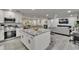 Open kitchen with granite countertops, stainless appliances, and views to the living room at 8222 Valrie Ln, Riverview, FL 33569
