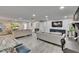 Bright living room with gray flooring, recessed lighting and contemporary furnishings throughout at 8222 Valrie Ln, Riverview, FL 33569