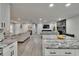 Open floor plan with kitchen island, fireplace, and views to the living room at 8222 Valrie Ln, Riverview, FL 33569