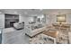 Open-concept living space features modern furniture, stylish decor, and a brick fireplace accent wall at 8222 Valrie Ln, Riverview, FL 33569