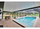 Relaxing screened pool featuring brick pavers and shaded seating areas for outdoor enjoyment at 8222 Valrie Ln, Riverview, FL 33569