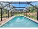 An enclosed pool surrounded by a brick paver patio and grassy backyard at 8222 Valrie Ln, Riverview, FL 33569