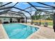 Large screened pool enclosure with lounge seating, offering both sun and shade for entertainment at 8222 Valrie Ln, Riverview, FL 33569
