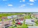 Aerial view of homes with lake views, showcasing a basketball court and manicured lawns at 8752 Loft Pt, Wesley Chapel, FL 33545