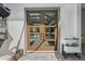 View of backyard pool through french doors with outdoor furniture nearby at 8752 Loft Pt, Wesley Chapel, FL 33545