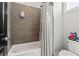 Bathroom with tub and shower featuring modern tile and fixtures at 8752 Loft Pt, Wesley Chapel, FL 33545