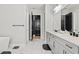 This bathroom features a dual sink vanity, a standalone tub, and black hardware accents throughout the space at 8752 Loft Pt, Wesley Chapel, FL 33545