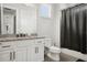 Bright bathroom featuring a white vanity with granite counters and a shower with a dark curtain at 8752 Loft Pt, Wesley Chapel, FL 33545