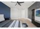 Modern bedroom with hardwood floors, ceiling fan and wall-mounted television at 8752 Loft Pt, Wesley Chapel, FL 33545
