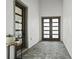 This entryway with stone paver flooring leads to double doors and a modern glass door at 8752 Loft Pt, Wesley Chapel, FL 33545
