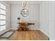 Bright foyer with hardwood floors, modern lighting, and an artful wood console table, making an inviting space at 8752 Loft Pt, Wesley Chapel, FL 33545