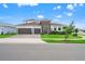 Beautiful two-story home with a modern design, two-car garage, and well-manicured lawn at 8752 Loft Pt, Wesley Chapel, FL 33545