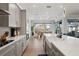 Modern kitchen featuring stone countertops, an island sink, stainless appliances, and hardwood floors at 8752 Loft Pt, Wesley Chapel, FL 33545