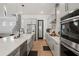 Contemporary kitchen with stainless appliances, marble backsplash, and an island with a sink, combining style and utility at 8752 Loft Pt, Wesley Chapel, FL 33545