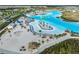 Aerial view of a vast lagoon featuring clear turquoise water, sandy beaches and recreational facilities at 8752 Loft Pt, Wesley Chapel, FL 33545
