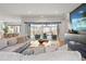 Light-filled living room with sliding glass doors opening to a patio, enhancing the sense of spaciousness and natural light at 8752 Loft Pt, Wesley Chapel, FL 33545