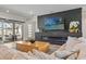 Cozy living room boasts a fireplace, large-screen TV, and sliding doors to a patio for relaxed indoor-outdoor living at 8752 Loft Pt, Wesley Chapel, FL 33545