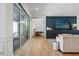 Bright living room featuring a fireplace with a sleek black tile wall and glass sliding doors to the patio at 8752 Loft Pt, Wesley Chapel, FL 33545