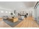 Spacious living room showcasing an open layout with a kitchen, and staircase to the upper floor at 8752 Loft Pt, Wesley Chapel, FL 33545