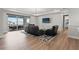 An open living area with a balcony, plush seating, TV, and a modern design at 8752 Loft Pt, Wesley Chapel, FL 33545