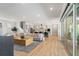Open-concept living space featuring a modern kitchen, comfortable seating, and ample natural light at 8752 Loft Pt, Wesley Chapel, FL 33545