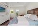 This comfy main bedroom has wood-look flooring and a tray ceiling with built in media center at 8752 Loft Pt, Wesley Chapel, FL 33545