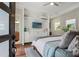This bright bedroom includes an ensuite bathroom, ceiling fan and textured wall feature at 8752 Loft Pt, Wesley Chapel, FL 33545