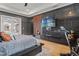Bedroom featuring a black marble accent wall, wood paneling, and outdoor pool access at 8752 Loft Pt, Wesley Chapel, FL 33545