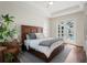 This main bedroom has hard floors, a stylish platform bed and a walk-out to the pool at 8752 Loft Pt, Wesley Chapel, FL 33545