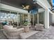 Covered outdoor living space features comfortable lounge furniture and a ceiling fan for added comfort at 8752 Loft Pt, Wesley Chapel, FL 33545