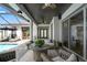 Stylish outdoor living space featuring modern furniture, ceiling fans and a view of the pool at 8752 Loft Pt, Wesley Chapel, FL 33545