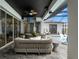 The outdoor patio features a wicker couch, tv and outdoor lounge area near the pool at 8752 Loft Pt, Wesley Chapel, FL 33545