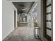 The outdoor patio has a comfortable wicker couch, fan, and tv for outdoor relaxing at 8752 Loft Pt, Wesley Chapel, FL 33545