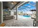 Relaxing pool area with comfortable lounge seating, an outdoor TV, and a sparkling pool with a spa at 8752 Loft Pt, Wesley Chapel, FL 33545