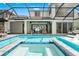 Beautifully designed screened-in pool and spa with an outdoor dining area and comfortable seating at 8752 Loft Pt, Wesley Chapel, FL 33545