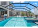 Inviting screened-in pool and spa with poolside seating, perfect for outdoor entertaining at 8752 Loft Pt, Wesley Chapel, FL 33545
