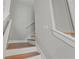 Wood-tread stairs with white risers and handrails, with bright, light-filled design at 8752 Loft Pt, Wesley Chapel, FL 33545