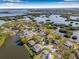 Stunning aerial view of a waterside home nestled among lush greenery, offering serene waterfront living and scenic beauty at 9011 Baywood Park Dr, Seminole, FL 33777