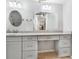 Bright bathroom featuring white cabinetry, quartz countertops, and large mirrors for a clean and modern aesthetic at 9011 Baywood Park Dr, Seminole, FL 33777