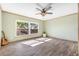 Inviting bedroom featuring natural light, wood flooring, and a scenic view, complemented by minimalist decor at 9011 Baywood Park Dr, Seminole, FL 33777