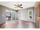 Bedroom with wood flooring, two windows, and sliding glass doors to an outdoor lanai at 9011 Baywood Park Dr, Seminole, FL 33777