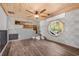 Bonus room with a wood ceiling, custom built-in shelves, an octagon window, and wood-look flooring at 9011 Baywood Park Dr, Seminole, FL 33777