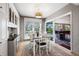 Bright breakfast nook featuring a modern light fixture, view of backyard, and gray patterned wallpaper at 9011 Baywood Park Dr, Seminole, FL 33777