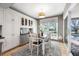 Cozy dining area featuring natural light, backyard views, and built-in cabinetry adjacent to the kitchen at 9011 Baywood Park Dr, Seminole, FL 33777