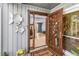 Close-up of an ornate carved wooden door with decorative fish and a 'Kashtan' welcome mat at 9011 Baywood Park Dr, Seminole, FL 33777