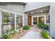 Inviting entryway featuring a decorative wooden front door and lush landscaping at 9011 Baywood Park Dr, Seminole, FL 33777