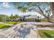 Charming home featuring mature landscaping, a brick-lined driveway, and a two-car garage at 9011 Baywood Park Dr, Seminole, FL 33777